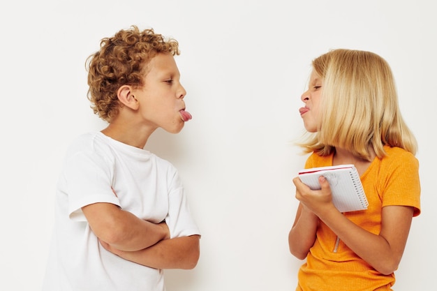 Photo sibling making faces against white background