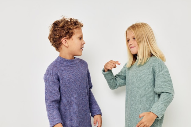 Photo sibling talking against white background