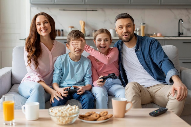 Siblings cover each others eyes during gaming