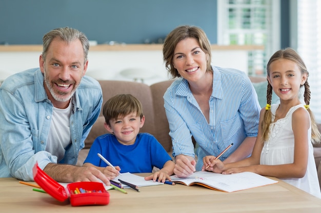 Siblings getting help with homework from parents