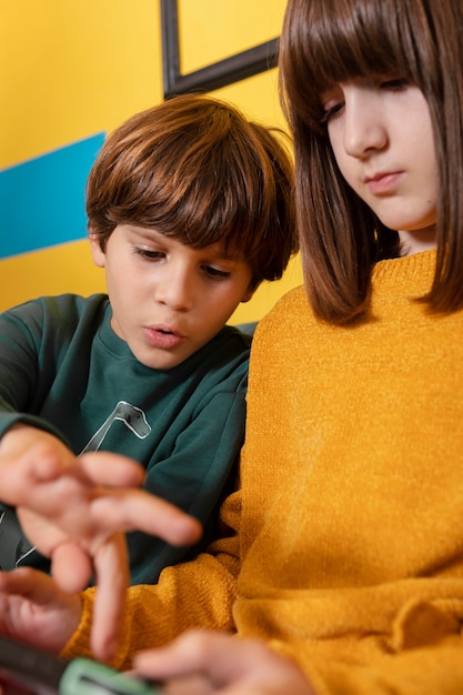 Siblings at home using tablet