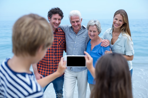 Siblings photographing family with mobile phone