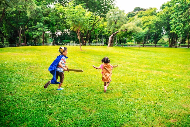 Photo siblings playful dressup park concept