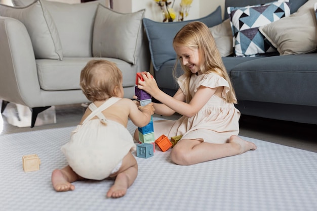 siblings playing with blocks at home