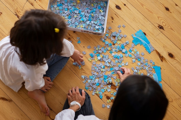 Siblings playing with brain teaser toys