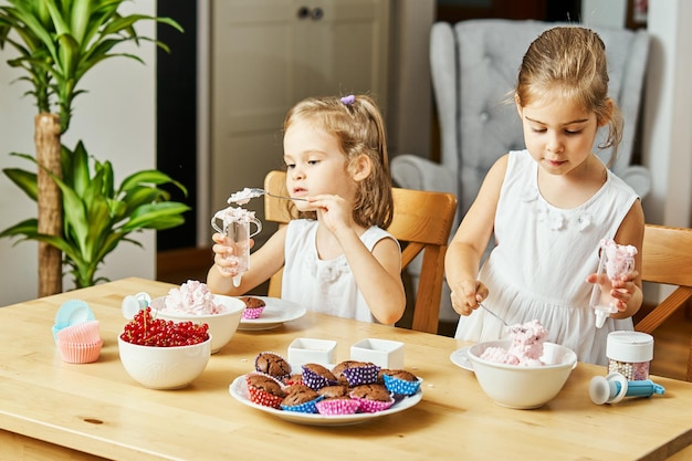 Siblings preparing food on table