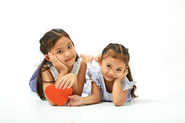 Siblings sitting of cute asian girl