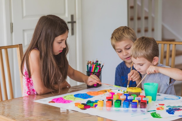 Siblings together create one picture at home