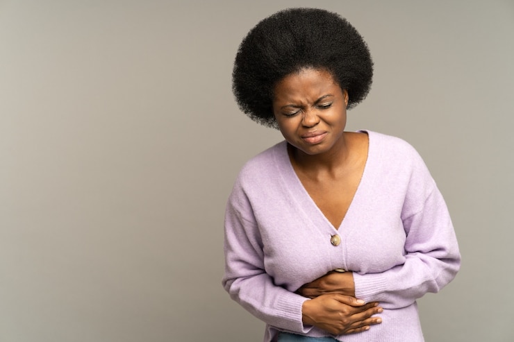 Photo sick african woman suffer acute period pain or ache in stomach pressing hands to abdominal belly