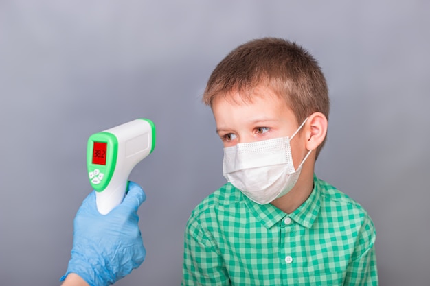 A sick child is measured with an infrared thermometer