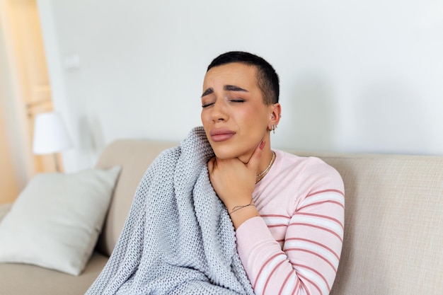 Sick day at home young woman has sore throat and common cold\
cough closeup of beautiful young woman caught cold or flu illness\
portrait of unhealthy girl with coronavirus covid19 symptoms