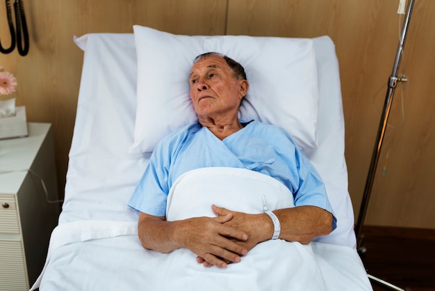 A sick elderly is staying at the hospital