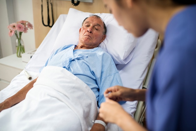 a sick elderly is staying at the hospital