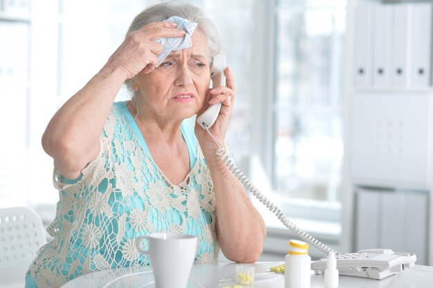 Sick elderly woman with medication