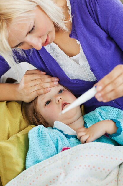 Sick female child lying on couch