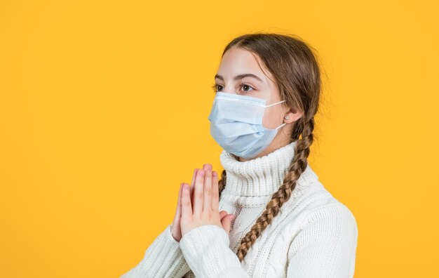 Sick girl kid in protection mask during covid19 pandemic outbreak meditating
