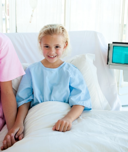 Sick little girl on a hospital bed 