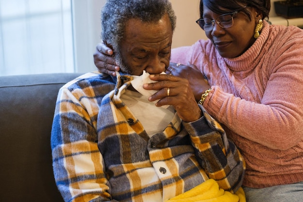 Sick man cared for by his wife to get well soon from the flu Concept illness health care senior couple