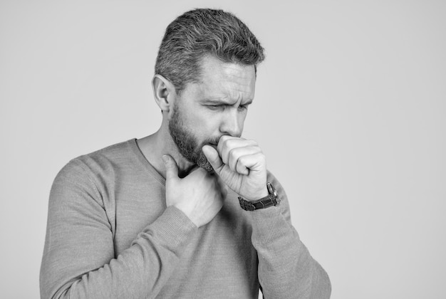 Sick man has cough on grey background mens health male casual fashion