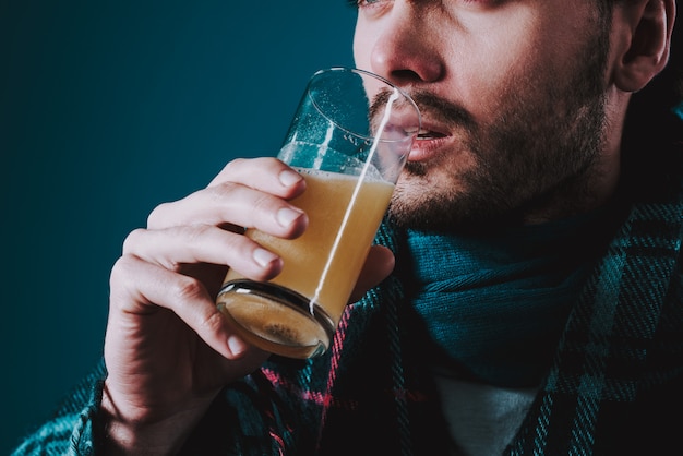 Photo sick man is drinking whispering pill.