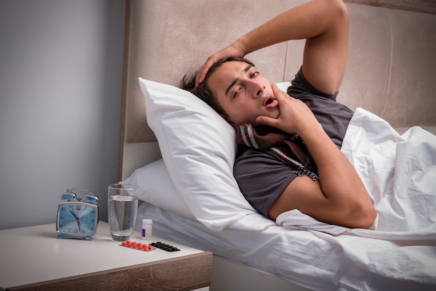 Sick man resting in the bed