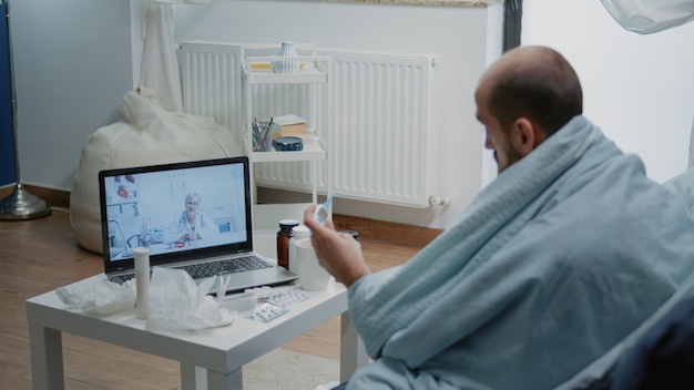 Photo sick man talking to doctor on video call for telemedicine