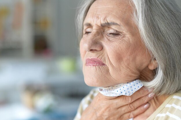 Sick senior woman posing at home