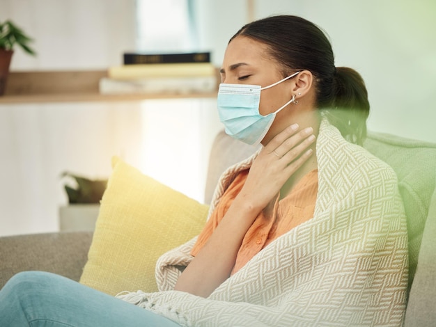 Sick virus and face mask with woman on sofa for sore throat illness and inflammation Allergy tired and fever with female patient in living room at home for pneumonia disease and fatigue