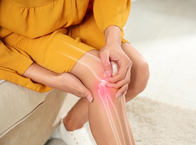 Sick woman at home closeup Digital compositing with illustration of knee joint