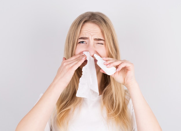 Sick woman instills drops in her nose