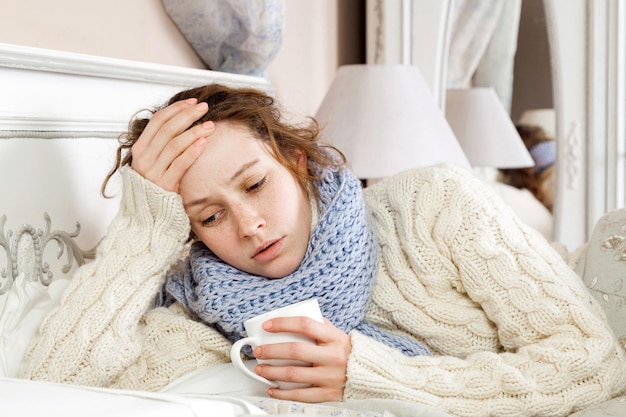 Sick woman lie down on her bed