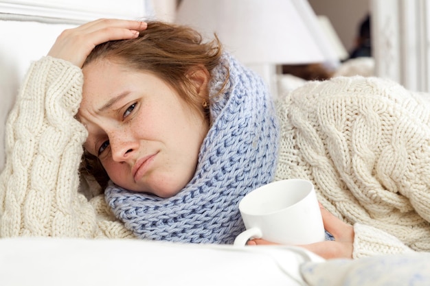 Sick woman lie down on her bed