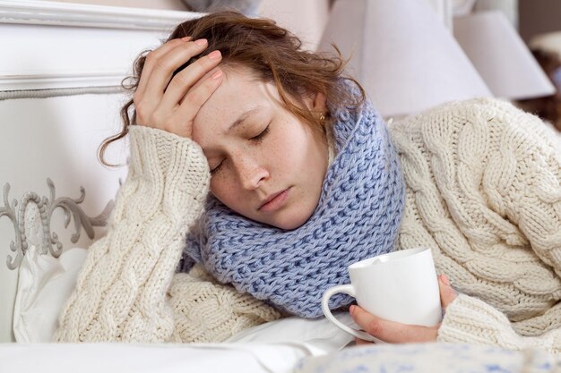 Sick woman lie down on her bed