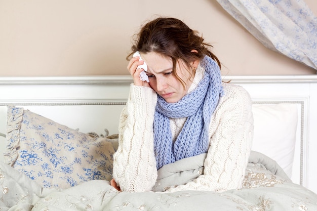 Sick woman lie down on her bed