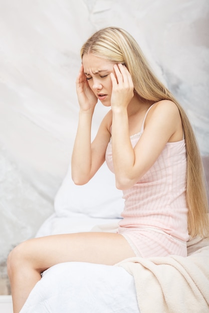 Sick woman lying in bed with high fever