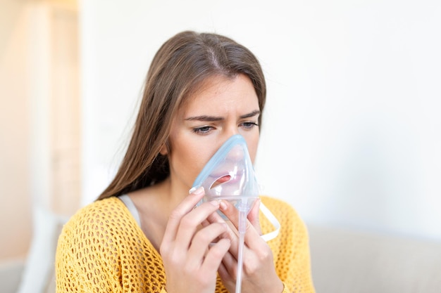 Sick woman making inhalation medicine is the best medicine Ill woman wearing an oxygen mask and undergoing treatment for covid19 woman with an inhaler