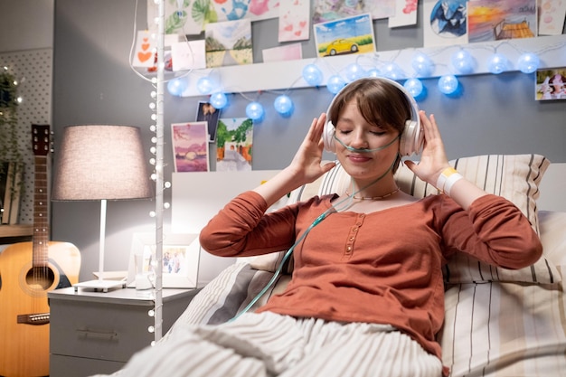 Sick woman making musical therapy during her treatment