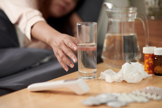 Sick Woman Taking Glass of Water