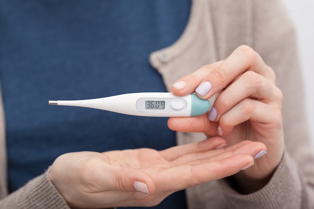 Sick women with a thermometer