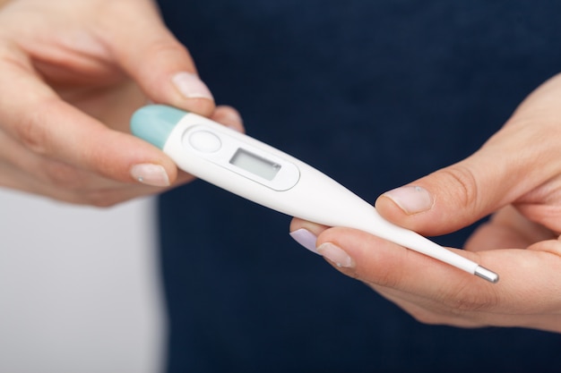 Sick women with a thermometer