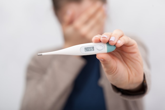 Sick women with a thermometer