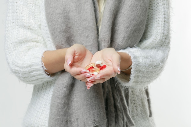 Photo sickness cute young blonde woman wrapped scarf having headache, touching her temple and closed eyes, closeup. cold, virus, migraine, flu season concept.