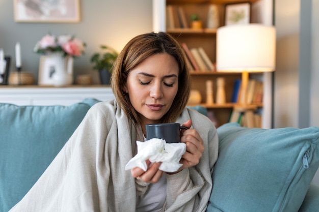 Sickness seasonal virus problem concept Woman being sick having flu lying on sofa Sick woman lying in bed with high fever Cold flu and migraine