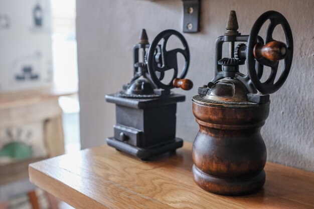 Photo side angel view of vintage hand manual coffee grinder