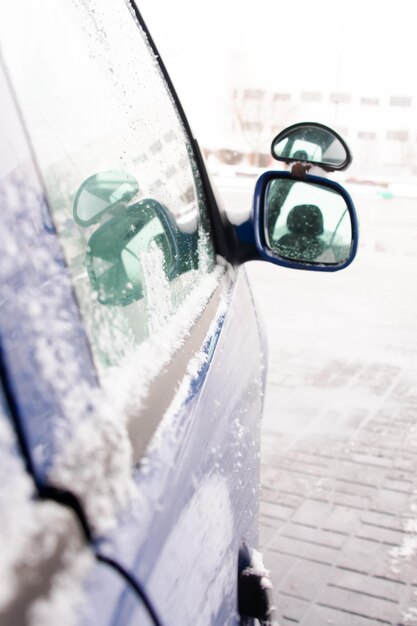 Side mirror of the car in the snow