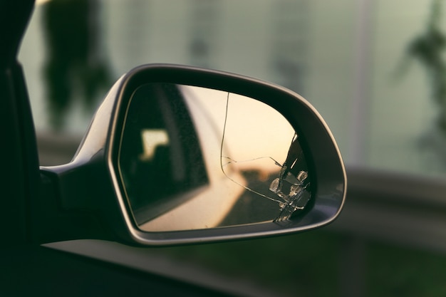 Photo side mirror of the car with a view back. broken mirror close up.