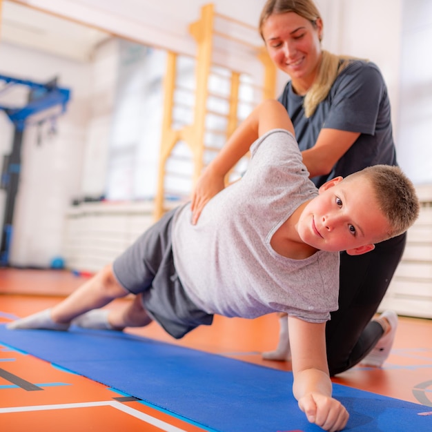 Side plank child exercising in a physical activity class