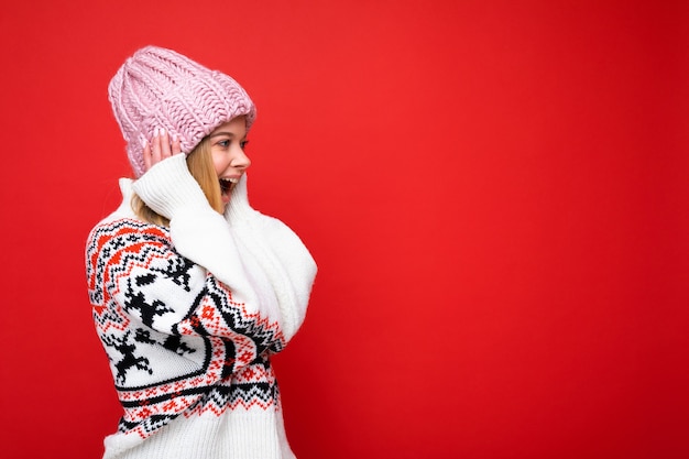 Side-profile photo of pretty astonished amazed happy young blonde woman standing isolated