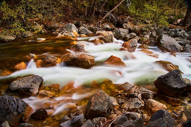 Side profile of river with water cascading over rocks