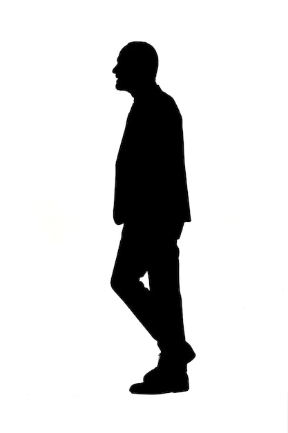 side silhouette of a man walking and dressed in a suit